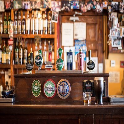 Irish pub with a selection of different beers and bottles in the background