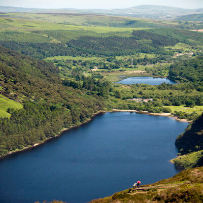Hilltop view of Lough Tay aka the Guinness lake with the white sand and dark, peaty waters